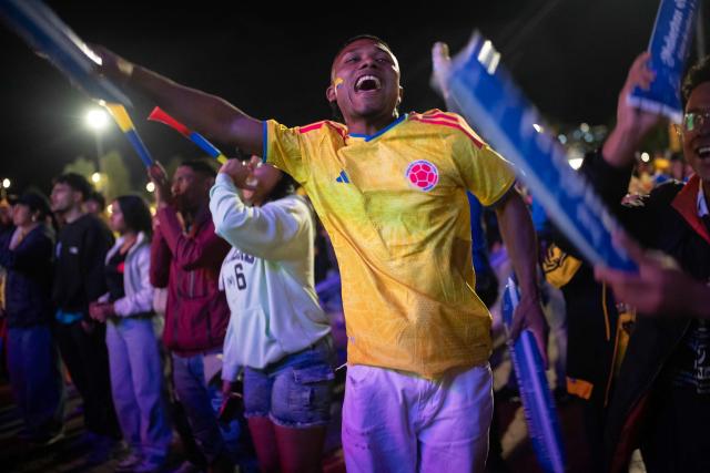 Colombia football fans cheer while watching the 2026 FIFA World Cup round of 32 match between Colombia and Ghana on a giant screen in Bogota on July 3, 2026. (Photo by ESTEBAN VEGA LA-ROTTA / AFP)