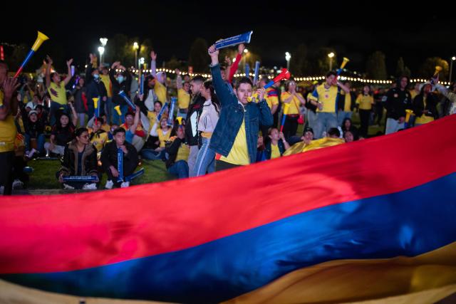 Colombia football fans cheer while watching the 2026 FIFA World Cup round of 32 match between Colombia and Ghana on a giant screen in Bogota on July 3, 2026. (Photo by ESTEBAN VEGA LA-ROTTA / AFP)