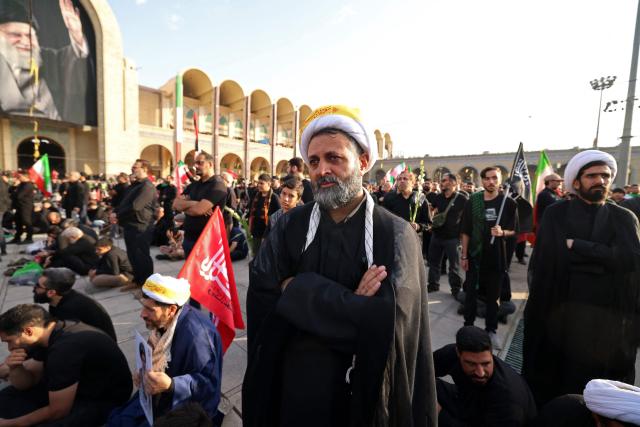 Mourners gather at the Grand Mosalla to pay their final respects to Iran's slain supreme leader Ayatollah Ali Khamenei at the start of his funeral ceremonies in Tehran on July 4, 2026. Funeral ceremonies for Iran's supreme leader Ali Khamenei officially began on July 4, state television reported, an event drawing thousands and intended to serve as a show of strength to the Islamic republic's foes. (Photo by Atta KENARE / AFP) / 