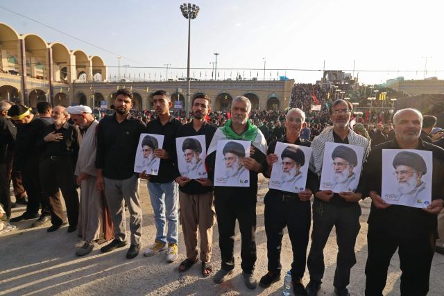 Mourners hold portraits of Iran's slain supreme leader Ayatollah Ali Khamenei at the start of his funeral ceremonies at the Grand Mosalla in Tehran on July 4, 2026. Funeral ceremonies for Iran's supreme leader Ali Khamenei officially began on July 4, state television reported, an event drawing thousands and intended to serve as a show of strength to the Islamic republic's foes. (Photo by Atta KENARE / AFP) / 