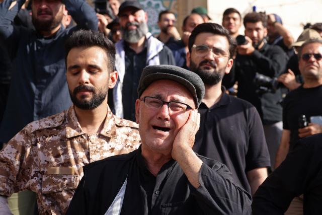 Mourners react while paying their final respects to Iran's slain supreme leader Ayatollah Ali Khamenei at the start of his funeral ceremonies at the Grand Mosalla in Tehran on July 4, 2026. Funeral ceremonies for Iran's supreme leader Ali Khamenei officially began on July 4, state television reported, an event drawing thousands and intended to serve as a show of strength to the Islamic republic's foes. (Photo by ATTA KENARE / AFP) / 