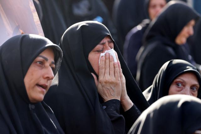 Mourners pay their final respects to Iran's slain supreme leader Ayatollah Ali Khamenei at the start of his funeral ceremonies at the Grand Mosalla in Tehran on July 4, 2026. Funeral ceremonies for Iran's supreme leader Ali Khamenei officially began on July 4, state television reported, an event drawing thousands and intended to serve as a show of strength to the Islamic republic's foes. (Photo by ATTA KENARE / AFP) / 
