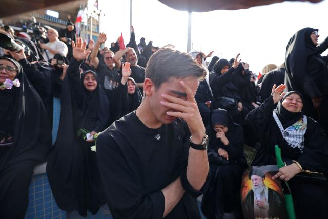 Mourners pay their final respects to Iran's slain supreme leader Ayatollah Ali Khamenei at the start of his funeral ceremonies at the Grand Mosalla in Tehran on July 4, 2026. Funeral ceremonies for Iran's supreme leader Ali Khamenei officially began on July 4, state television reported, an event drawing thousands and intended to serve as a show of strength to the Islamic republic's foes. (Photo by ATTA KENARE / AFP) / 