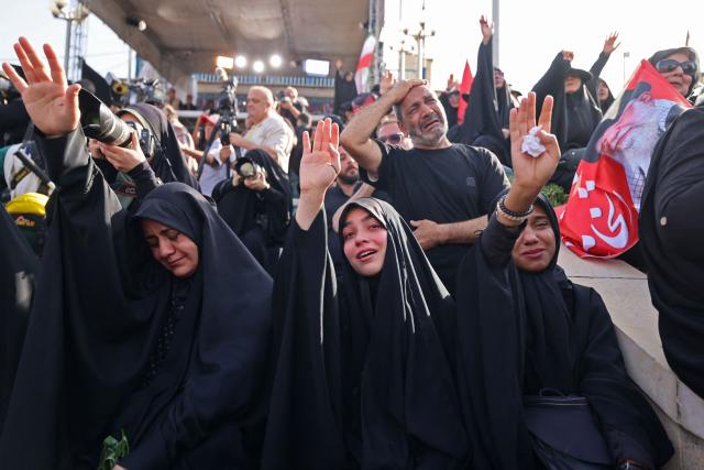 Mourners pay their final respects to Iran's slain supreme leader Ayatollah Ali Khamenei at the start of his funeral ceremonies at the Grand Mosalla in Tehran on July 4, 2026. Funeral ceremonies for Iran's supreme leader Ali Khamenei officially began on July 4, state television reported, an event drawing thousands and intended to serve as a show of strength to the Islamic republic's foes. (Photo by ATTA KENARE / AFP) / 