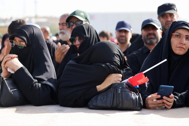 Mourners react while paying their final respects to Iran's slain supreme leader Ayatollah Ali Khamenei at the start of his funeral ceremonies at the Grand Mosalla in Tehran on July 4, 2026. Funeral ceremonies for Iran's supreme leader Ali Khamenei officially began on July 4, state television reported, an event drawing thousands and intended to serve as a show of strength to the Islamic republic's foes. (Photo by ATTA KENARE / AFP) / 