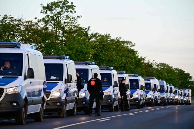 Police vehicles are stationed on an access road near in Erfurt, eastern Germany on July 4, 2026, in view of demonstrations against the party congress of far-right Alternative for Germany (AfD) will be held from July 4-5 at the Messe Erfurt fairground. German police are bracing to guard an annual congress of the far-right AfD party this weekend against tens of thousands of antifascist demonstrators who are determined to shut it down. The standoff in the city of Erfurt, Thuringia state, comes as the opposition Alternative for Germany party is soaring in national opinion polls ahead of all other parties. (Photo by John MACDOUGALL / AFP)