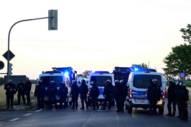 Police block a road to the Messe Erfurt fairground in Erfurt, eastern Germany on early July 4, 2026, in view of demonstrations against the party congress of far-right Alternative for Germany (AfD) that will be held from July 4-5. German police are bracing to guard an annual congress of the far-right AfD party this weekend against tens of thousands of antifascist demonstrators who are determined to shut it down. The standoff in the city of Erfurt, Thuringia state, comes as the opposition Alternative for Germany party is soaring in national opinion polls ahead of all other parties. (Photo by John MACDOUGALL / AFP)
