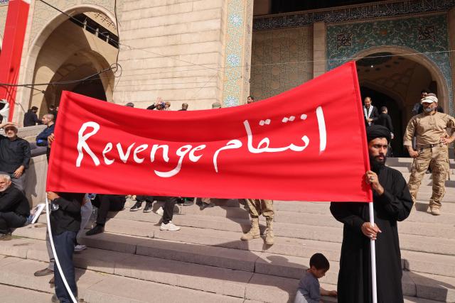 Mourners hold a banner at the Grand Mosalla during the funeral ceremonies of Iran's slain supreme leader Ayatollah Ali Khamenei, in Tehran on July 4, 2026. Funeral ceremonies for Iran's supreme leader Ali Khamenei officially began on July 4, state television reported, an event drawing thousands and intended to serve as a show of strength to the Islamic republic's foes. (Photo by ATTA KENARE / AFP) / 