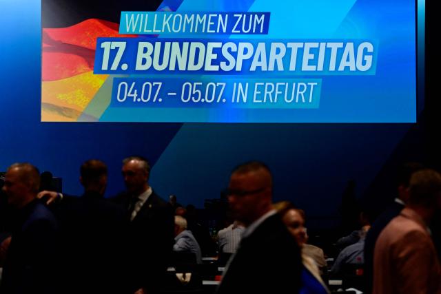 Delegates arrive at the party congress of far-right Alternative for Germany (AfD) at the Messe Erfurt fairground in Erfurt, eastern Germany on early July 4, 2026. German police are bracing to guard an annual congress of the far-right AfD party this weekend (July 4-5) against tens of thousands of antifascist demonstrators who are determined to shut it down. The standoff in the city of Erfurt, Thuringia state, comes as the opposition Alternative for Germany party is soaring in national opinion polls ahead of all other parties. (Photo by John MACDOUGALL / AFP)
