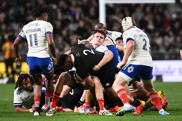 New Zealand's Codie Taylor (C) is tackled by France's Marko Gazzotti during the rugby Nations Championship match between New Zealand and France at One New Zealand Stadium in Christchurch on July 4, 2026. (Photo by Sanka VIDANAGAMA / AFP)