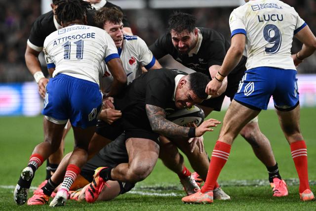 New Zealand's Codie Taylor (C) is tackled during the rugby Nations Championship match between New Zealand and France at One New Zealand Stadium in Christchurch on July 4, 2026. (Photo by Sanka VIDANAGAMA / AFP)
