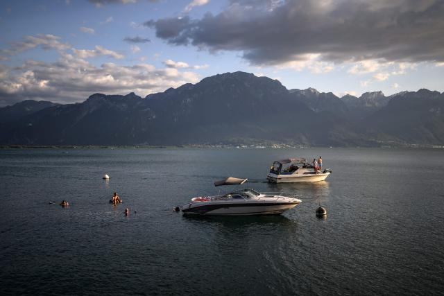 Festival-goers swim in Lake Geneva off Montreux during the opening day of the 60th Montreux Jazz Festival in Montreux, Switzerland, on July 3, 2026. (Photo by Fabrice COFFRINI / AFP)