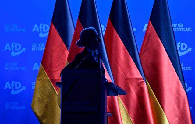 Co-leader of the far-right Alternative for Germany (AfD) party Alice Weidel watches a projection during her speech at the party congress of far-right Alternative for Germany (AfD) at the Messe Erfurt fairground in Erfurt, eastern Germany on July 4, 2026. About 20,000 people flocked to Erfurt, in Thuringia state, according to police, to protest against the Alternative for Germany (AfD) party that tops national opinion polls. (Photo by John MACDOUGALL / AFP)