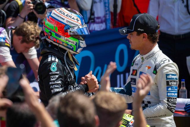 Mercedes' Italian driver Kimi Antonelli (L) and McLaren's British driver Lando Norris (R) shake hands following the sprint race ahead of the Formula One British Grand Prix at the Silverstone motor racing circuit in Silverstone, central England, on July 4, 2026. (Photo by Ben STANSALL / AFP)