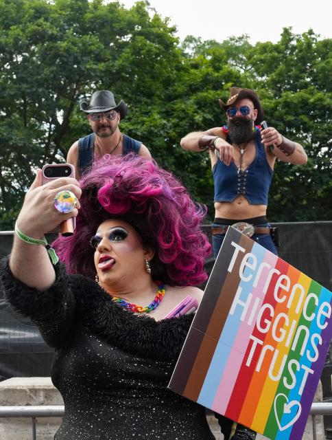 A participant takes a selfie as people take part in the annual Pride Parade, in celebration and support of the lesbian, gay, bisexual and transgender (LGBT+) community, in London on July 4, 2026. (Photo by CARLOS JASSO / AFP)