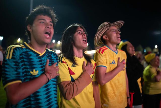 Colombia football fans sing the national anthem while watching the 2026 FIFA World Cup round of 32 match between Colombia and Ghana on a giant screen in Bogota on July 3, 2026. (Photo by ESTEBAN VEGA LA-ROTTA / AFP)