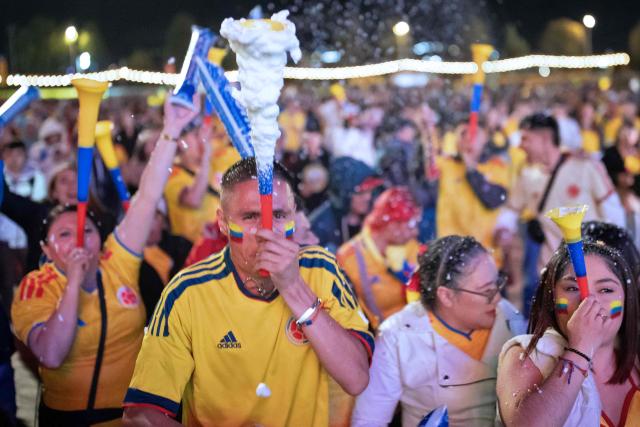 Colombia football fans celebrate after winning the 2026 FIFA World Cup round of 32 match against Ghana on a giant screen in Bogota on July 3, 2026. (Photo by ESTEBAN VEGA LA-ROTTA / AFP)