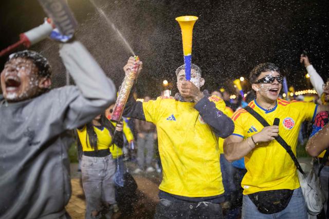 Colombia football fans celebrate after winning the 2026 FIFA World Cup round of 32 match against Ghana on a giant screen in Bogota on July 3, 2026. (Photo by ESTEBAN VEGA LA-ROTTA / AFP)