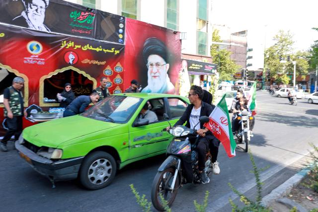 Mourners make their way to the Grand Mosalla to pay their final respects to Iran's slain supreme leader Ayatollah Ali Khamenei during his funeral ceremonies in Tehran on July 4, 2026. Vast crowds of Iranians loyal to the Islamic republic massed in Tehran on July 4 to begin almost a week of funeral ceremonies for slain supreme leader Ali Khamenei, which authorities want to send a message of defiance to the West after the war with the United States and Israel. (Photo by AFP) / 
