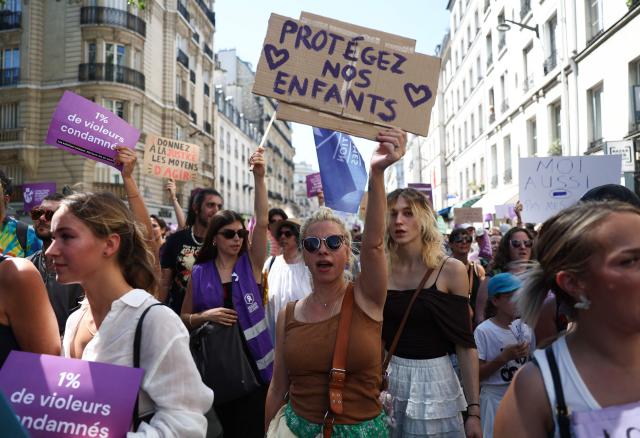 A protester holds a placard reading "Protect our children" during a demonstration against sexual violence against women and children, called by the Women's Foundation, at Place de la Bastille central Paris, on July 4, 2026. (Photo by ROMAIN PERROCHEAU / AFP)