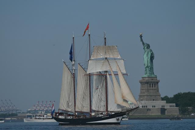 A tall ship sails past the Statue of Liberty during Sail 4th 250 in New York, on July 4, 2026. Millions of Americans celebrated the country's 250th birthday on Saturday -- a landmark celebration that comes at a time of deep political division, with a president determined to put his stamp on the festivities. Washington's traditional fireworks display on the National Mall -- lined with monuments celebrating the nation's Founding Fathers -- has been super-sized, and is being touted as the biggest ever. (Photo by ANGELA WEISS / AFP)