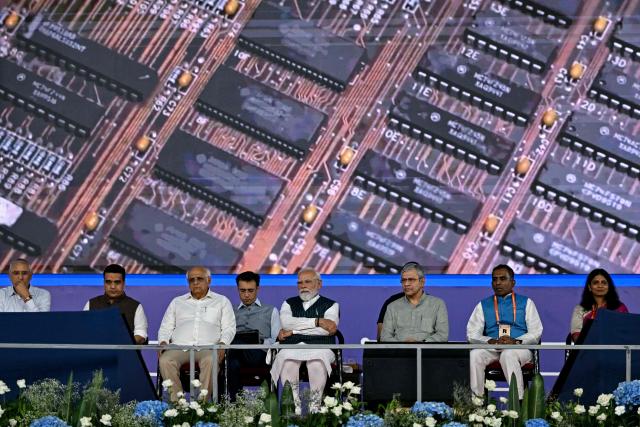 India's Prime Minister Narendra Modi (4R), Railways, Electronics and Information Technology Minister Ashwini Vaishnaw (3R), CG Power and Industrial Solutions Chairman Vellayan Subbiah (2R), Renesas Electronics India President and Vice President Malini Narayanamoorthi (R) and Gujarat state Chief Minister Bhupendrabhai Patel (3L) attend the inauguration of chipmaker CG Semi's OSAT (outsourced semiconductor assembly and testing) facility in Sanand on July 4, 2026. (Photo by Shammi MEHRA / AFP)