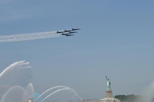 US military planes fly over the Statue of Liberty during Sail 4th 250 in New York, on July 4, 2026. Millions of Americans celebrated the country's 250th birthday on Saturday -- a landmark celebration that comes at a time of deep political division, with a president determined to put his stamp on the festivities. Washington's traditional fireworks display on the National Mall -- lined with monuments celebrating the nation's Founding Fathers -- has been super-sized, and is being touted as the biggest ever. (Photo by ANGELA WEISS / AFP)