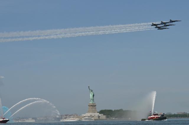 US military planes fly over the Statue of Liberty during Sail 4th 250 in New York, on July 4, 2026. Millions of Americans celebrated the country's 250th birthday on Saturday -- a landmark celebration that comes at a time of deep political division, with a president determined to put his stamp on the festivities. Washington's traditional fireworks display on the National Mall -- lined with monuments celebrating the nation's Founding Fathers -- has been super-sized, and is being touted as the biggest ever. (Photo by ANGELA WEISS / AFP)