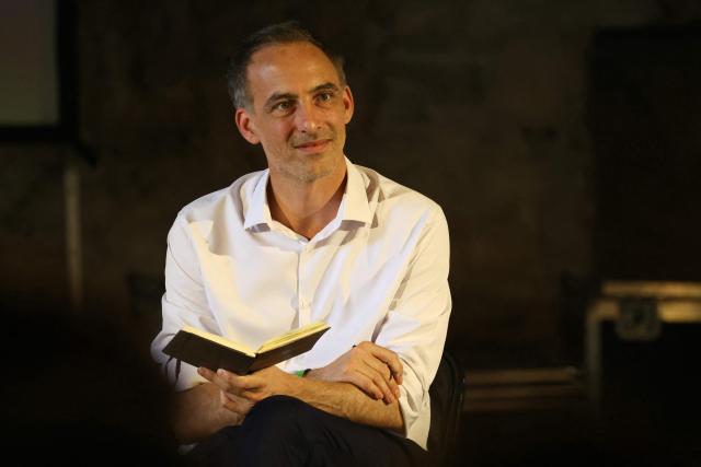 Place publique's centre-left party leader and MEP Raphael Glucksmann looks on as he takes part in the 6th edition of Le Festival des Idées ("Ideas' Festival") in La Charité-sur-Loire, central France on July 4, 2026. From July 3 to 5, 2026, the festival hosts around forty prominent guests from various backgrounds for a series of debates aiming "to discuss the major challenges facing society and explore constructive solutions for the future" of France. (Photo by Alain JOCARD / AFP)