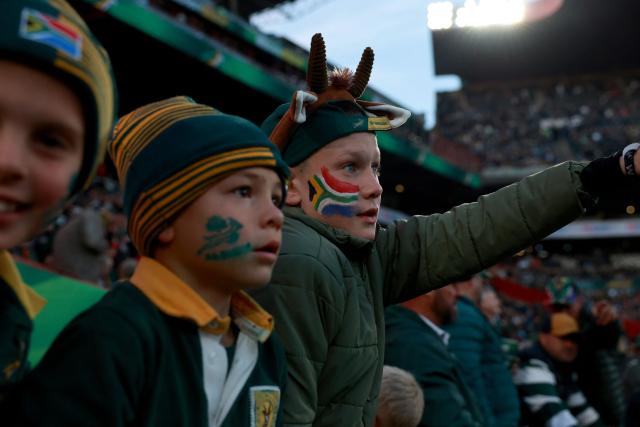 Young South African supporters sport flags painted on their cheecks during the warm up ahead of the rugby Nations Championship match between South Africa and England at Ellis Park Stadium in Johannesburg on July 4, 2026. (Photo by PHILL MAGAKOE / AFP)