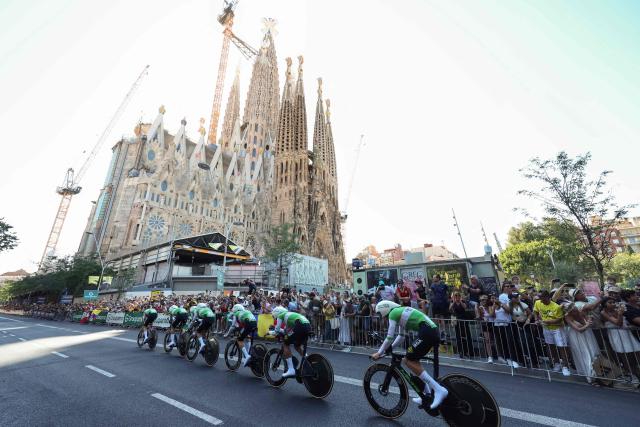 Caja Rural-Seguros RGA team riders cycle past the Sagrada Familia Basilica during the 1st stage of the 113th edition of the Tour de France cycling race, a 19,6 km team time trial stage in and around Barcelona in northeastern Spain, on July 4, 2026. (Photo by Josep LAGO / AFP)