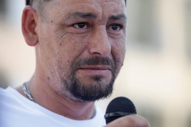 Louis's father Nicolas Herve speaks as attendees gather to pay tribute to Louis, a teenager killed in an ambush in Narbonne, in Carcassonne, southwestern France, on July 4, 2026. Several hundred people took part on July 4, 2026, afternoon in Carcassonne in a silent march for Louis, a 17-year-old teenager who died at the end of June from injuries sustained in a beating, on the site of a construction project in Narbonne, on the evening of June 19, during an ambush filmed by his attackers. Left unconscious at the scene, he was hospitalized the next day after being discovered by a worker, but died from his injuries on June 23. (Photo by Valentine CHAPUIS / AFP)