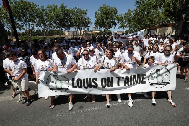 Demonstrators hold a banner reading "Louis we love you" as they attend a tribute march to Louis, a teenager killed in an ambush in Narbonne, in Carcassonne, southwestern France, on July 4, 2026. Several hundred people took part on July 4, 2026, afternoon in Carcassonne in a silent march for Louis, a 17-year-old teenager who died at the end of June from injuries sustained in a beating, on the site of a construction project in Narbonne, on the evening of June 19, during an ambush filmed by his attackers. Left unconscious at the scene, he was hospitalized the next day after being discovered by a worker, but died from his injuries on June 23. (Photo by Valentine CHAPUIS / AFP)