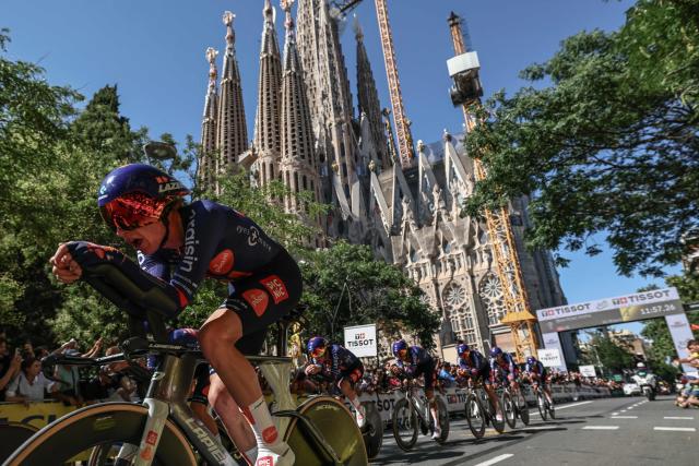 Picnic-PostNL team riders cycle past the Sagrada Familia Basilica during the 1st stage of the 113th edition of the Tour de France cycling race, a 19,6 km team time trial stage in and around Barcelona in northeastern Spain, on July 4, 2026. (Photo by Anne-Christine POUJOULAT / AFP)