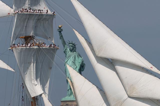 A tall ship sails past the Statue of Liberty during Sail 4th 250 in New York, on July 4, 2026. Millions of Americans celebrated the country's 250th birthday on Saturday -- a landmark celebration that comes at a time of deep political division, with a president determined to put his stamp on the festivities. Washington's traditional fireworks display on the National Mall -- lined with monuments celebrating the nation's Founding Fathers -- has been super-sized, and is being touted as the biggest ever. (Photo by TIMOTHY A. CLARY / AFP)