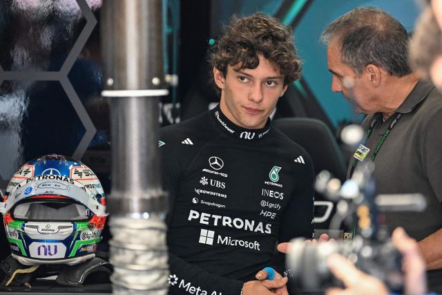 Mercedes' Italian driver Kimi Antonelli (L) speaks with his dad Marco Antonelli (R) before the qualifying session ahead of the Formula One British Grand Prix at the Silverstone motor racing circuit in Silverstone, central England, on July 4, 2026. (Photo by PETER POWELL / POOL / AFP)