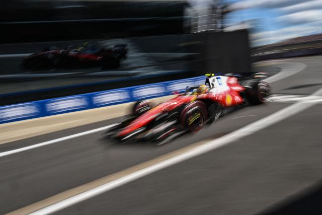 Ferrari's British driver Lewis Hamilton drives through pit lane as he takes part in the qualifying session ahead of the Formula One British Grand Prix at the Silverstone motor racing circuit in Silverstone, central England, on July 4, 2026. (Photo by PETER POWELL / AFP)