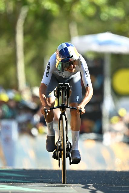Pinarello Q36.5 Pro Cycling Team's British rider Tom Pidcock cycles to the finish line of the 1st stage of the 113th edition of the Tour de France cycling race, a 19,6 km team time trial stage in and around Barcelona in northeastern Spain, on July 4, 2026. (Photo by Loic VENANCE / AFP)