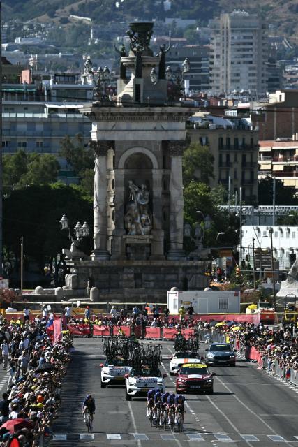 The team Picnic-PostNL cycles next to the Plaça d'Espanya during the 1st stage of the 113th edition of the Tour de France cycling race, a 19,6 km team time trial stage in and around Barcelona in northeastern Spain, on July 4, 2026. (Photo by Jeff PACHOUD / AFP)