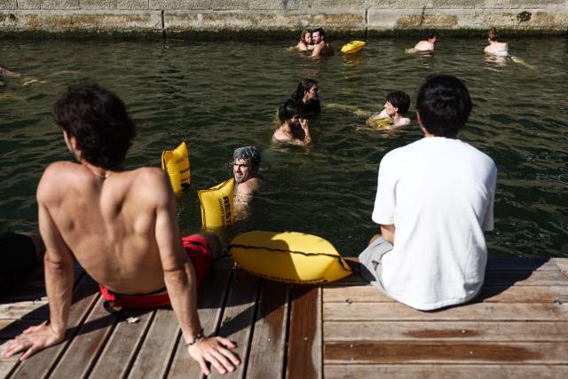 Swimmers bathe on the opening day of the swimming areas on the Seine river, in Paris, on July 4, 2026. (Photo by ROMAIN PERROCHEAU / AFP)