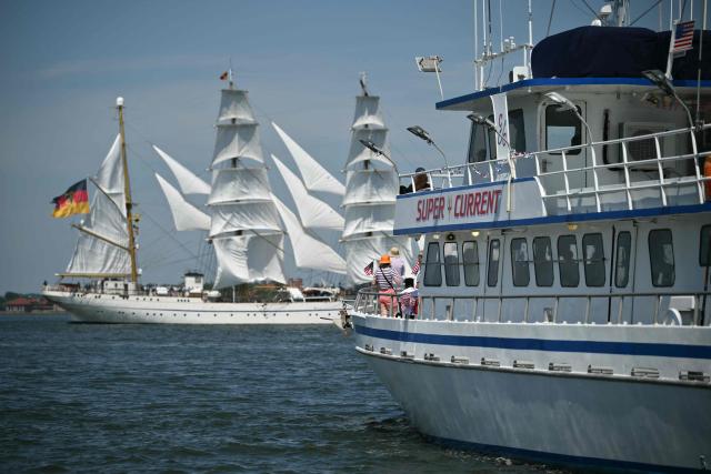 A charter fishing boat (R) is seen as German tall ship Gorch Fock sails in the distance during the Sail 4th 250 Parade of Ships in New York harbor in New York, on July 4, 2026. Millions of Americans celebrated the country's 250th birthday on Saturday -- a landmark celebration that comes at a time of deep political division, with a president determined to put his stamp on the festivities. Washington's traditional fireworks display on the National Mall -- lined with monuments celebrating the nation's Founding Fathers -- has been super-sized, and is being touted as the biggest ever. (Photo by ANGELA WEISS / AFP)