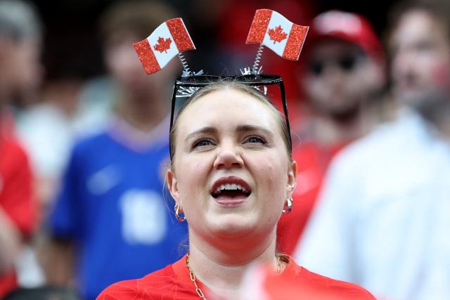 A Canadian fan cheers for her team ahead of the 2026 World Cup round of 16 football match between Canada and Morocco at the Houston Stadium in Houston on July 4, 2026.  (Photo by Thomas COEX / AFP)