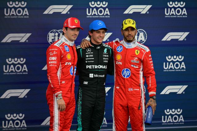 Mercedes' Italian driver Kimi Antonelli (C) poses after taking pole position with second-fastest Ferrari's Monegasque driver Charles Leclerc (L) and third-fastest Ferrari's British driver Lewis Hamilton (R) in the qualifying session ahead of the Formula One British Grand Prix at the Silverstone motor racing circuit in Silverstone, central England, on July 4, 2026. (Photo by Andrej ISAKOVIC / AFP)