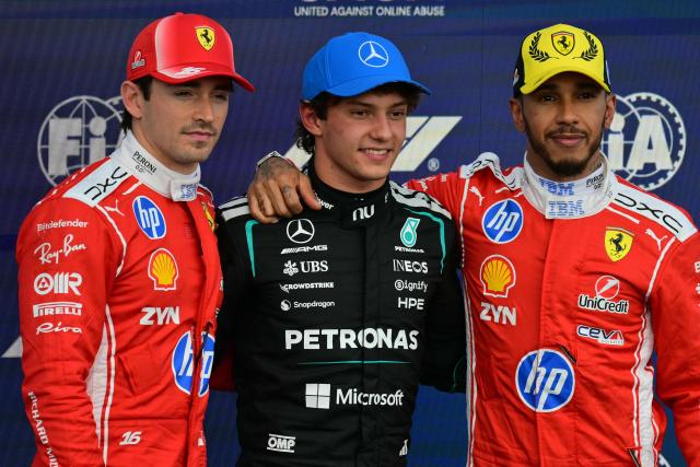 Mercedes' Italian driver Kimi Antonelli (C) poses after taking pole position with second-fastest Ferrari's Monegasque driver Charles Leclerc (L) and third-fastest Ferrari's British driver Lewis Hamilton (R) in the qualifying session ahead of the Formula One British Grand Prix at the Silverstone motor racing circuit in Silverstone, central England, on July 4, 2026. (Photo by Andrej ISAKOVIC / AFP)
