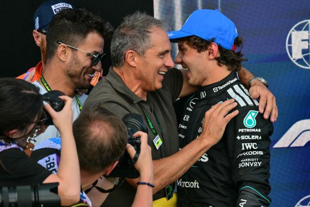 Mercedes' Italian driver Kimi Antonelli (R) celebrates with his father Marco (C) after taking pole position in the qualifying session ahead of the Formula One British Grand Prix at the Silverstone motor racing circuit in Silverstone, central England, on July 4, 2026. (Photo by Andrej ISAKOVIC / AFP)
