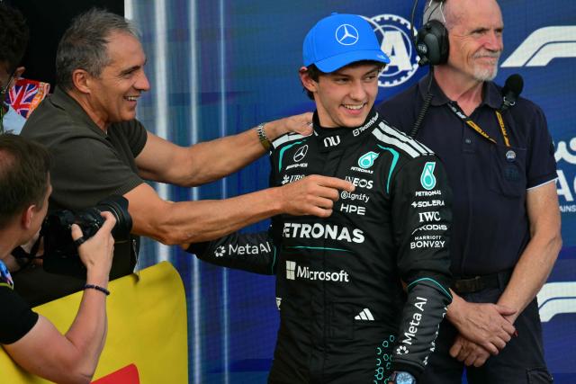 Mercedes' Italian driver Kimi Antonelli (R) celebrates with his father Marco (L) after taking pole position in the qualifying session ahead of the Formula One British Grand Prix at the Silverstone motor racing circuit in Silverstone, central England, on July 4, 2026. (Photo by Andrej ISAKOVIC / AFP)