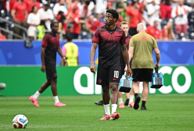 Canada's forward #10 Jonathan David warms up ahead of the 2026 World Cup round of 16 football match between Canada and Morocco at the Houston Stadium in Houston on July 4, 2026.  (Photo by Paul ELLIS / AFP)