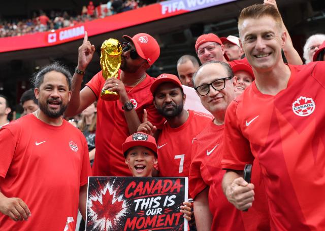 Canadian fans pose for a photo ahead of the 2026 World Cup round of 16 football match between Canada and Morocco at the Houston Stadium in Houston on July 4, 2026.  (Photo by Thomas COEX / AFP)