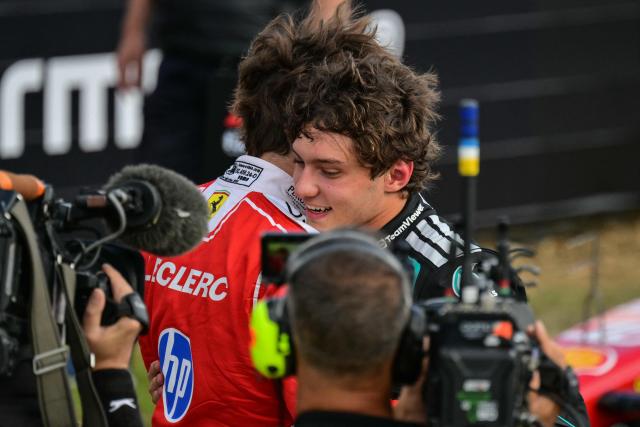 Mercedes' Italian driver Kimi Antonelli (R) embraces Ferrari's Monegasque driver Charles Leclerc after they finish with the first and second fastest times in the qualifying session ahead of the Formula One British Grand Prix at the Silverstone motor racing circuit in Silverstone, central England, on July 4, 2026. (Photo by Andrej ISAKOVIC / AFP)