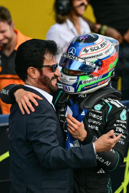 Mercedes' Italian driver Kimi Antonelli (R) is congratulated by FIA president Ben Sulayem after taking pole position in the qualifying session ahead of the Formula One British Grand Prix at the Silverstone motor racing circuit in Silverstone, central England, on July 4, 2026. (Photo by Andrej ISAKOVIC / AFP)